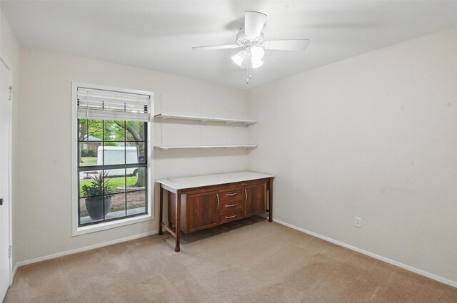 unfurnished room with ceiling fan, light carpet, and baseboards