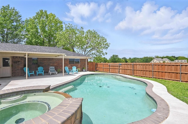 view of pool featuring a patio, a fenced backyard, and a pool with connected hot tub