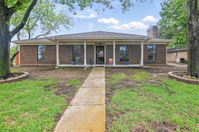 view of front of property featuring a chimney, brick siding, and a porch