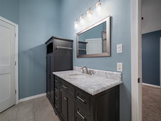 bathroom featuring tile patterned floors, vanity, and baseboards