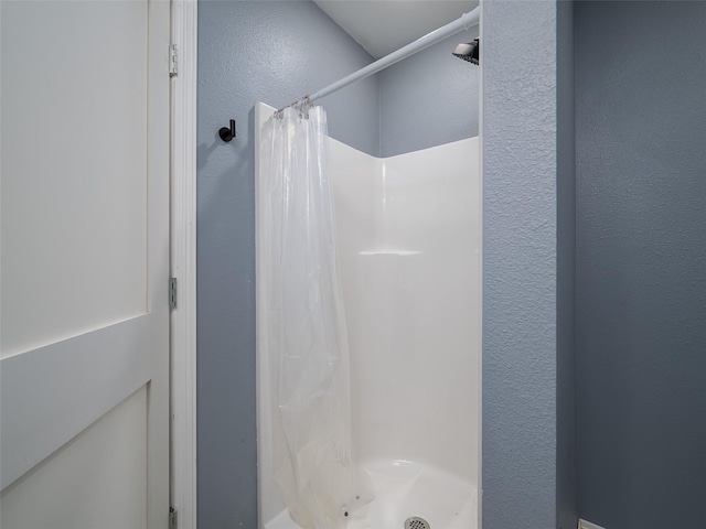 bathroom with a shower with curtain
