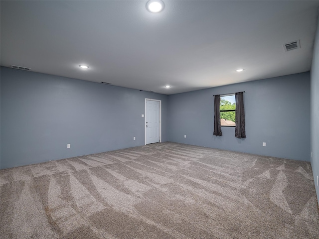 carpeted empty room featuring recessed lighting and visible vents