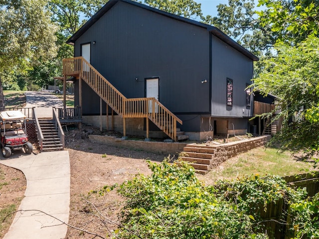 rear view of house featuring stairs
