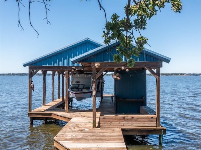 dock area with a water view and boat lift