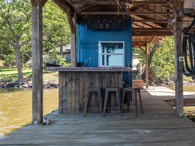 view of outbuilding featuring outdoor dry bar and a water view