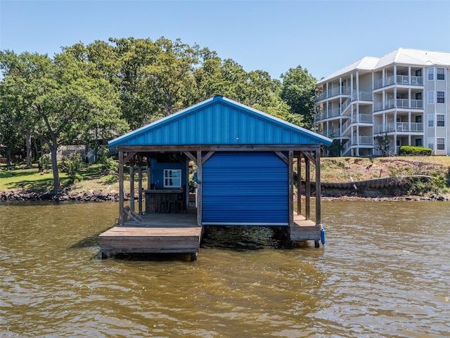 view of dock with boat lift and a water view