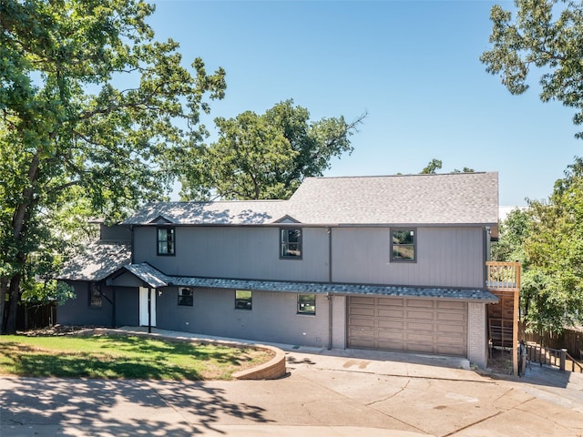 view of front of home featuring brick siding, fence, a shingled roof, concrete driveway, and an attached garage