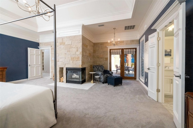 bedroom featuring a fireplace, a notable chandelier, visible vents, ornamental molding, and light colored carpet