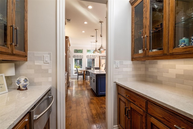 bar with decorative backsplash, a chandelier, recessed lighting, a warming drawer, and dark wood finished floors