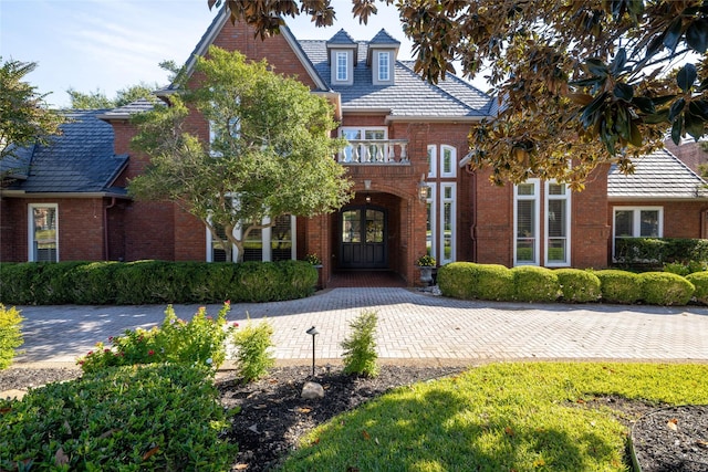 view of front of house featuring french doors and brick siding