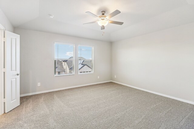 unfurnished bedroom featuring baseboards, ceiling fan, lofted ceiling, and light colored carpet