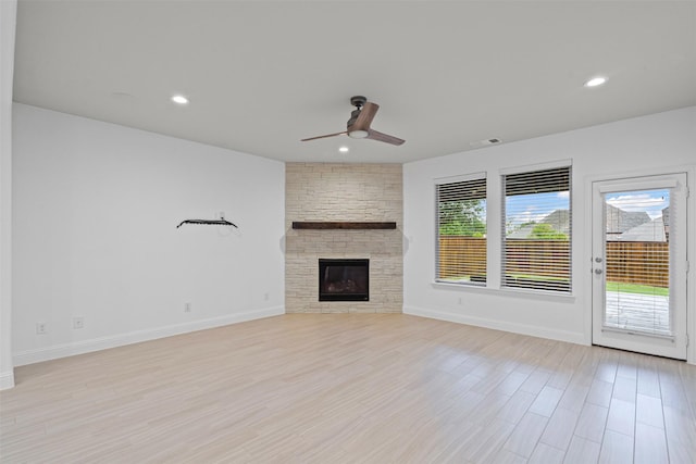 unfurnished living room featuring recessed lighting, a fireplace, a sink, baseboards, and a ceiling fan