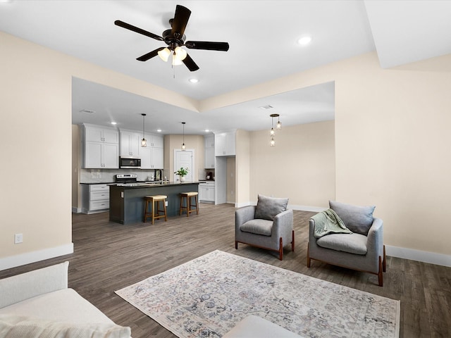 5525 Vesta Farley Rd, Fort Worth, TX 76119 - living area with wood finished floors, ceiling fan, recessed lighting, and baseboards