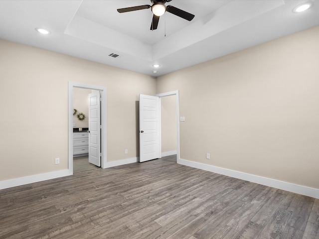 5525 Vesta Farley Rd, Fort Worth, TX 76119 - unfurnished bedroom featuring wood finished floors, visible vents, a raised ceiling, and recessed lighting