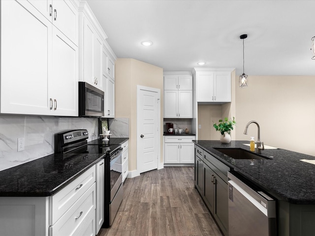 5525 Vesta Farley Rd, Fort Worth, TX 76119 - kitchen with dark wood finished floors, appliances with stainless steel finishes, white cabinets, backsplash, and a sink