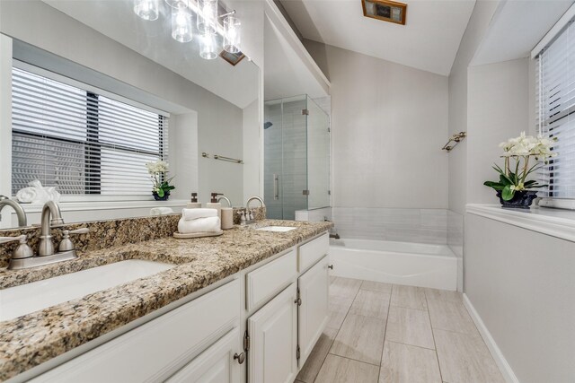bathroom featuring double vanity, a shower stall, a bath, and a sink