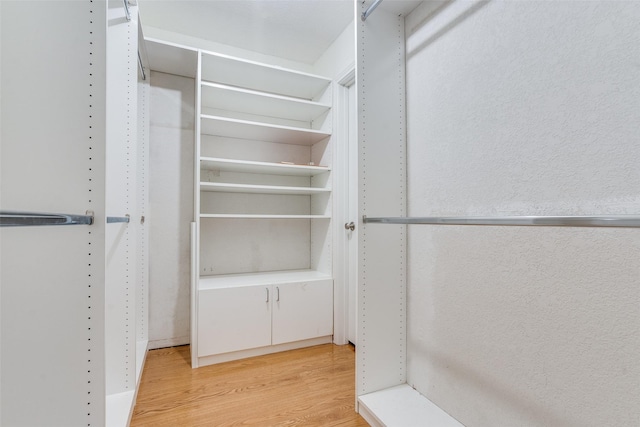 spacious closet featuring light wood finished floors