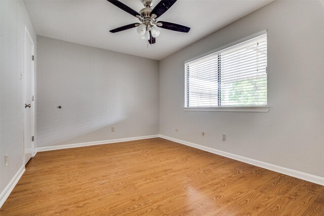 unfurnished room with ceiling fan, light wood-type flooring, and baseboards