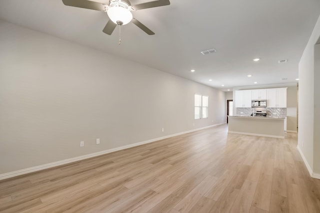 unfurnished living room featuring light wood finished floors, recessed lighting, ceiling fan, visible vents, and baseboards
