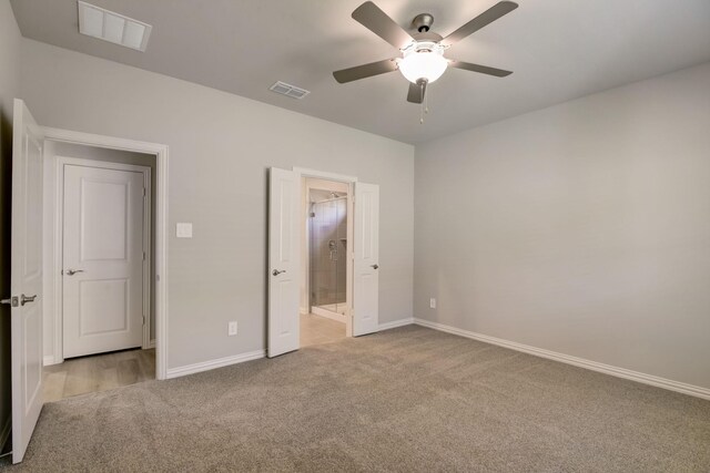 unfurnished bedroom featuring visible vents, ensuite bathroom, carpet flooring, and baseboards