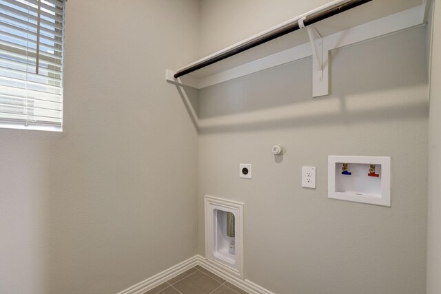 clothes washing area featuring washer hookup, gas dryer hookup, electric dryer hookup, baseboards, and laundry area