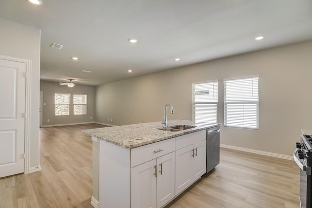 kitchen with baseboards, stainless steel appliances, light wood-style floors, and a sink