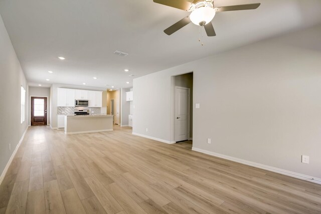 unfurnished living room with visible vents, baseboards, recessed lighting, light wood finished floors, and a ceiling fan