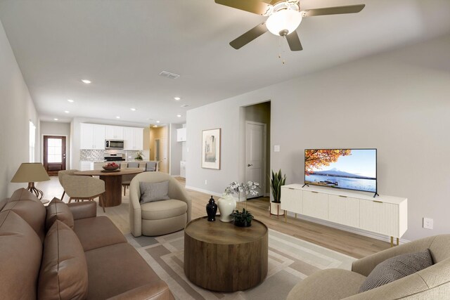 living room with visible vents, baseboards, light wood-type flooring, recessed lighting, and a ceiling fan