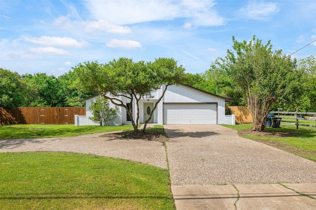 view of front of property featuring fence, driveway, an attached garage, and a front yard