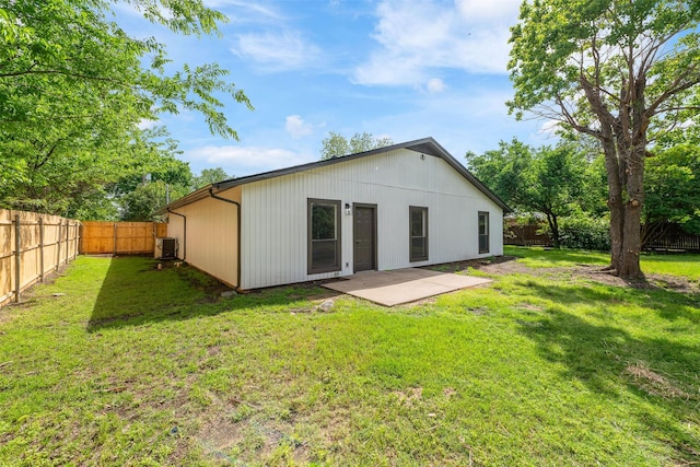 back of property featuring a lawn, a patio, and a fenced backyard