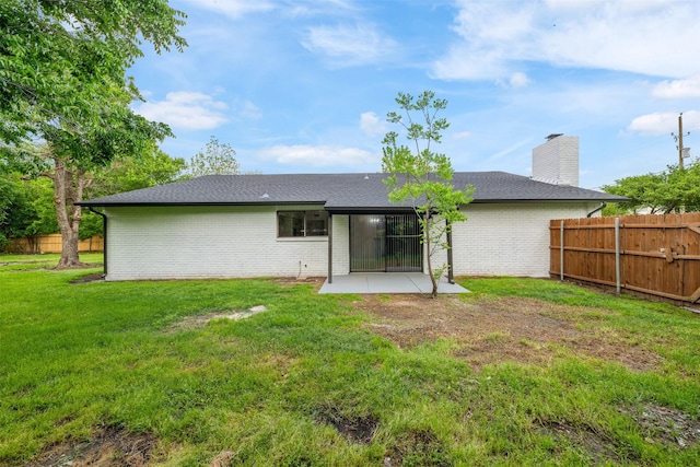 back of property featuring brick siding, fence, and a patio area