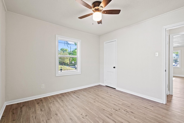 900 W Coffin St, Denison, TX 75020 - spare room with light wood-style floors, baseboards, ornamental molding, and ceiling fan