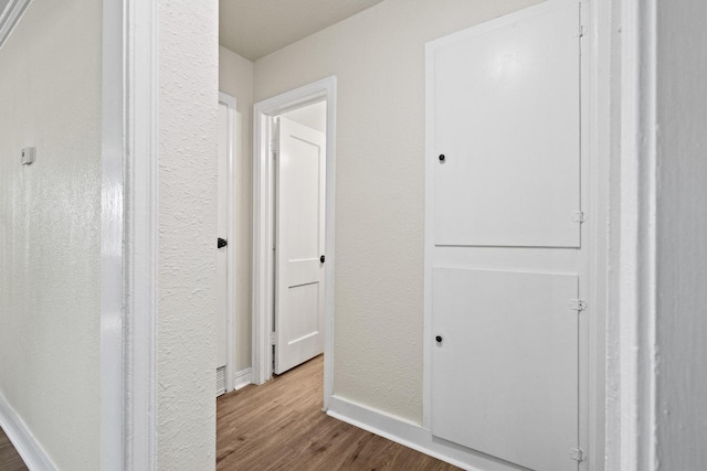 900 W Coffin St, Denison, TX 75020 - hallway with wood finished floors and baseboards