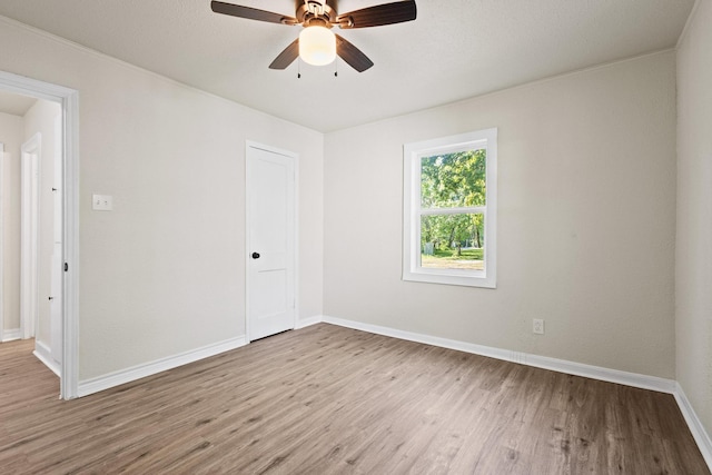 900 W Coffin St, Denison, TX 75020 - empty room with wood finished floors, ceiling fan, and baseboards