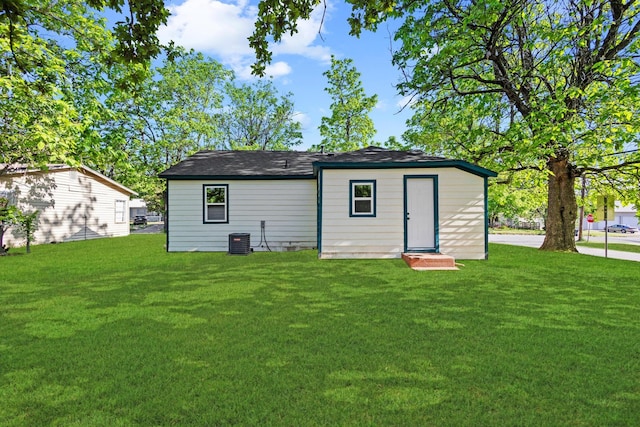 900 W Coffin St, Denison, TX 75020 - back of property with a lawn and central air condition unit
