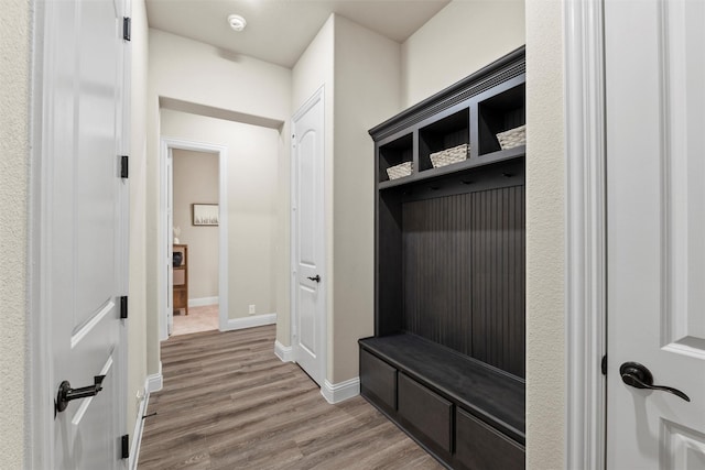 mudroom featuring wood finished floors and baseboards
