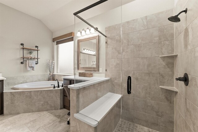 full bath featuring a stall shower, a garden tub, lofted ceiling, and vanity