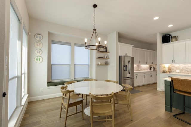 dining area featuring recessed lighting, baseboards, light wood finished floors, and a chandelier
