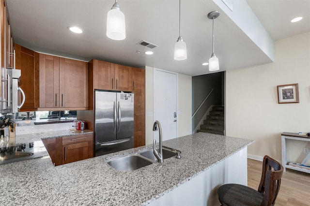 2608 Museum Way Unit 3407, Fort Worth, TX 76107 - kitchen with a sink, visible vents, stainless steel appliances, light wood finished floors, and hanging light fixtures