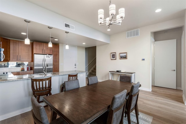 2608 Museum Way Unit 3407, Fort Worth, TX 76107 - dining space with visible vents, a notable chandelier, stairs, and light wood-style floors