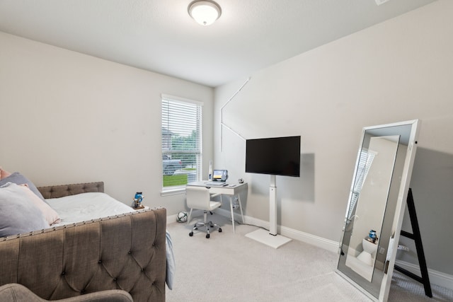 bedroom featuring carpet floors, baseboards, and an office area