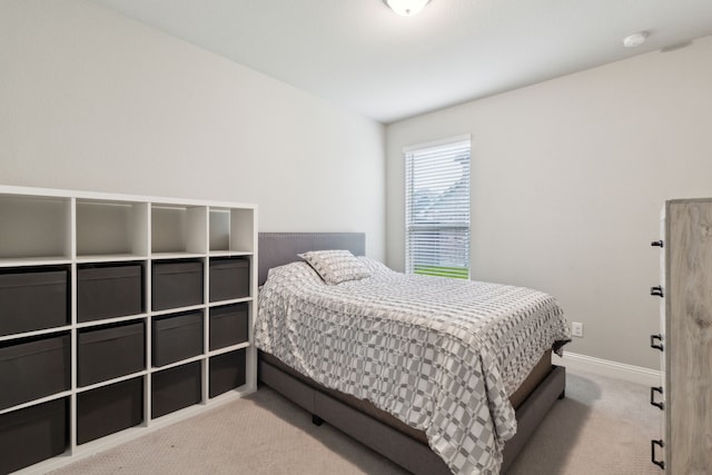 bedroom with carpet flooring and baseboards