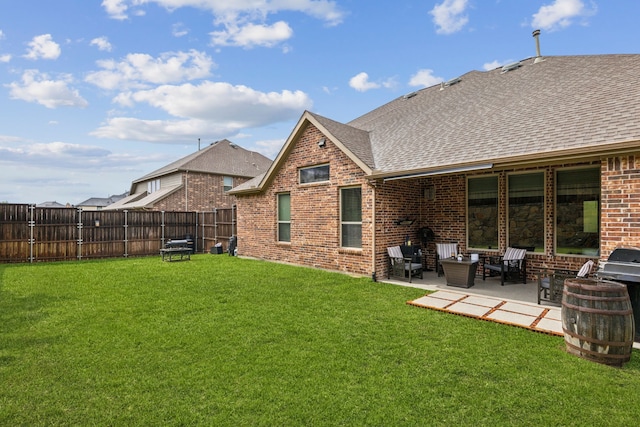 back of house featuring a shingled roof, brick siding, and a patio
