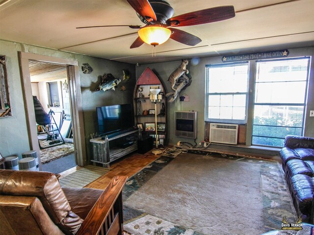 living area with heating unit, ceiling fan, and cooling unit