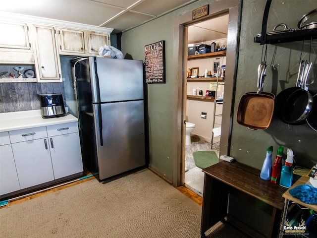 kitchen featuring light countertops and freestanding refrigerator