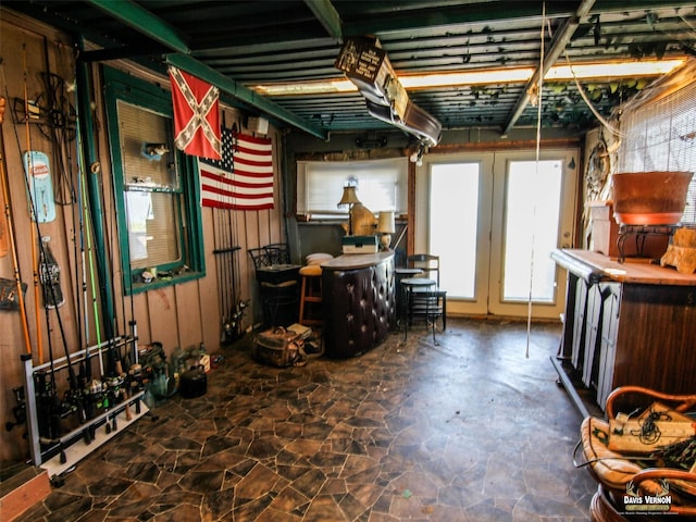 basement featuring stone flooring and a healthy amount of sunlight