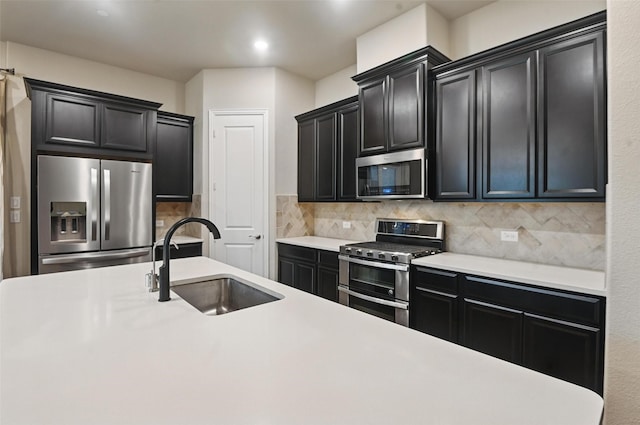 1331 Bailey Ln, Allen, TX 75013 - kitchen with decorative backsplash, dark cabinets, appliances with stainless steel finishes, a sink, and light countertops