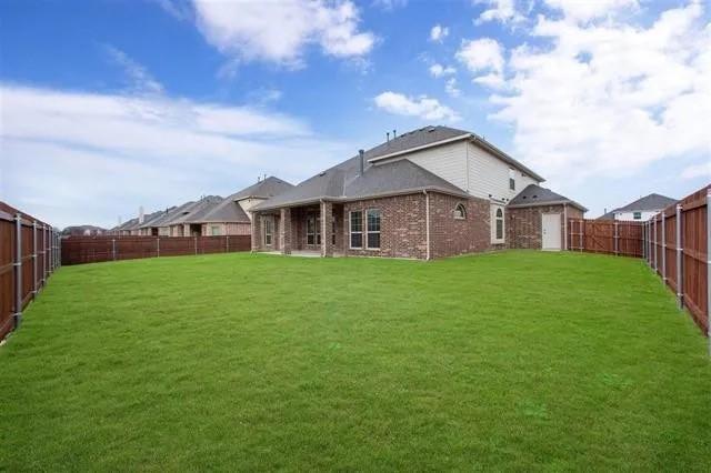 4502 Longbourn Dr, Mansfield, TX 76063 - rear view of property with a yard, brick siding, and a fenced backyard