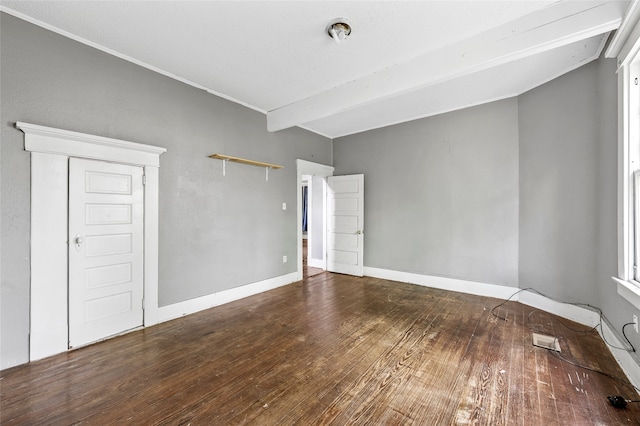 unfurnished room with lofted ceiling with beams, visible vents, wood finished floors, and baseboards