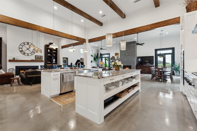 kitchen featuring finished concrete floors, open floor plan, and a fireplace